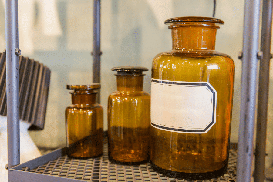 Amber glass laboratory reagent bottles with screw caps on a clean lab bench used for chemical storage