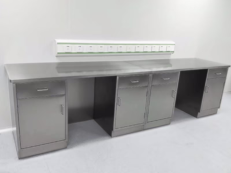 Stainless steel lab table with integrated drawer pedestals and welded frame in a modern laboratory
